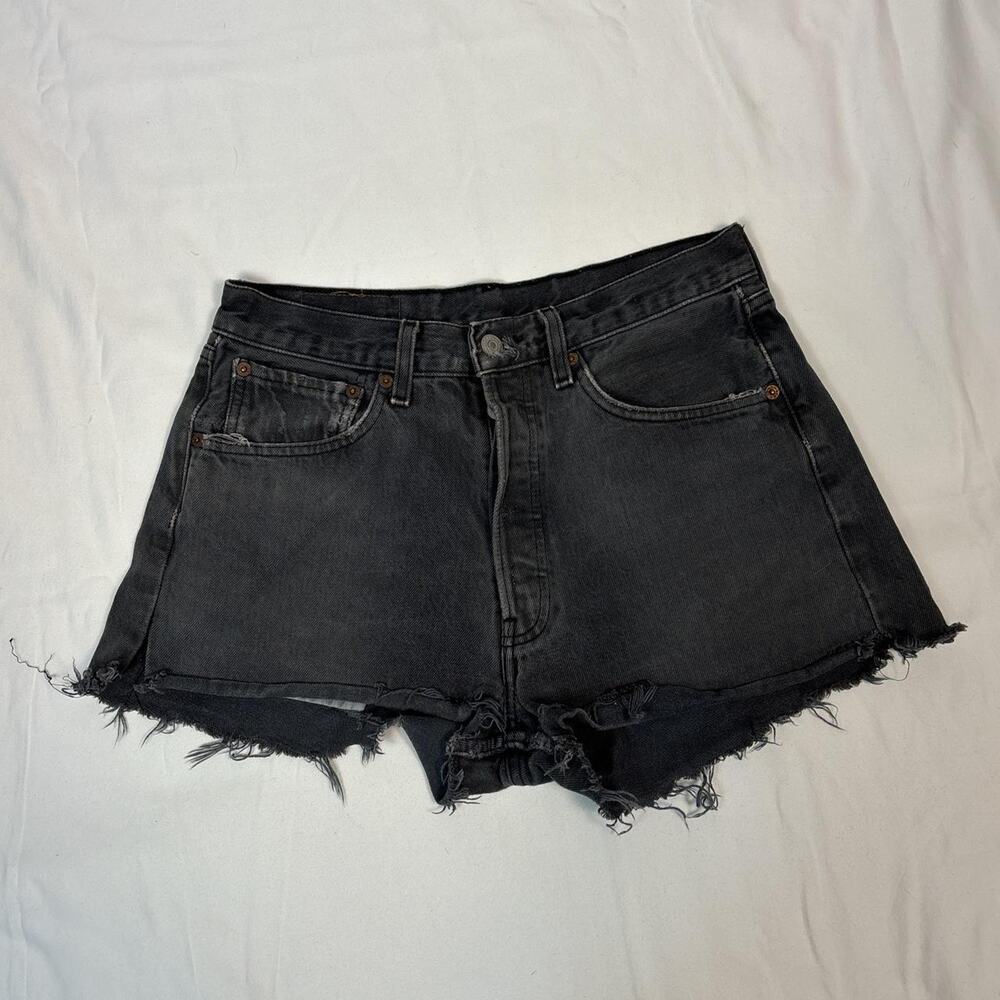 Vintage Leviโs distressed black denim shorts